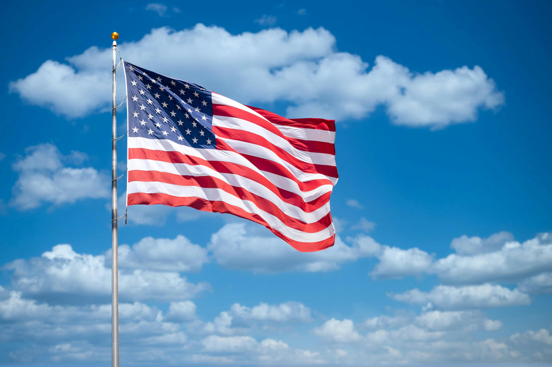 Bright blue sky with a vibrant American flag waving in the breeze, symbolizing patriotism and unity